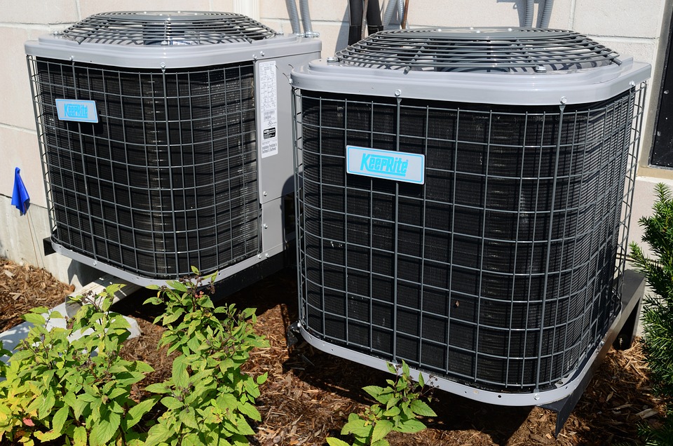 Two climate control air conditioning units installed outside a building.